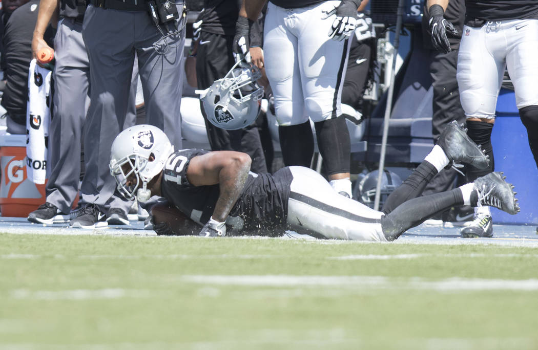 Oakland Raiders wide receiver Michael Crabtree (15) after being tackled in the first half of the NFL game against the Tennessee Titans at the Nissan Stadium in Nashville, Tenn., Sunday, Sept. 10,  ...