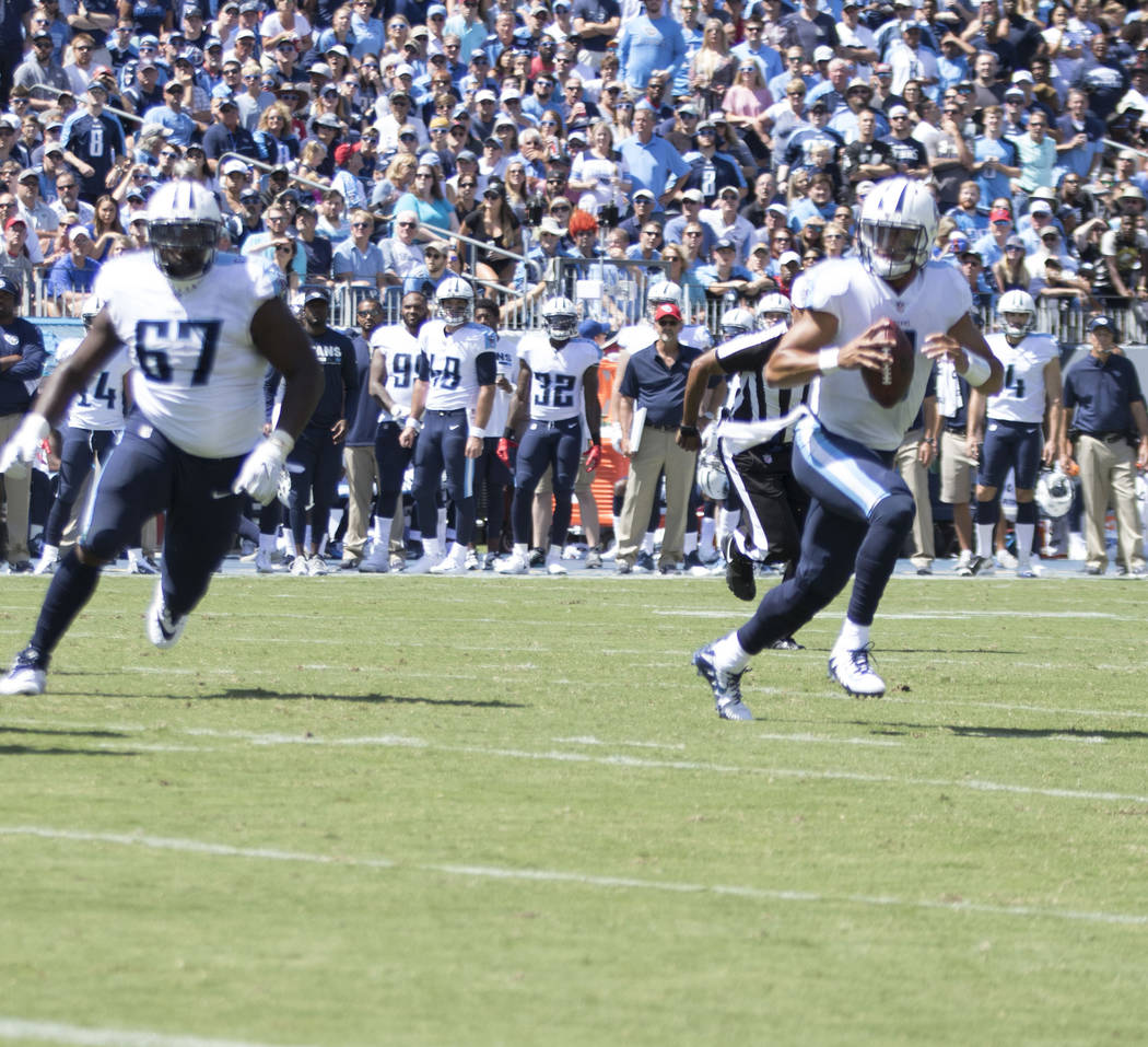 Tennessee Titans quarterback Marcus Mariota (8) scrambles with the football in the first half of the game against the Oakland Raiders at the Nissan Stadium in Nashville, Tenn., Sunday, Sept. 10, 2 ...