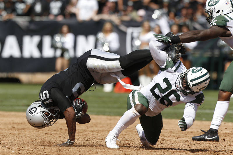 Sep 17, 2017; Oakland, CA, USA; Oakland Raiders wide receiver Michael Crabtree (15) is upended by New York Jets free safety Marcus Maye (26) after making a catch in the second quarter at Oakland C ...