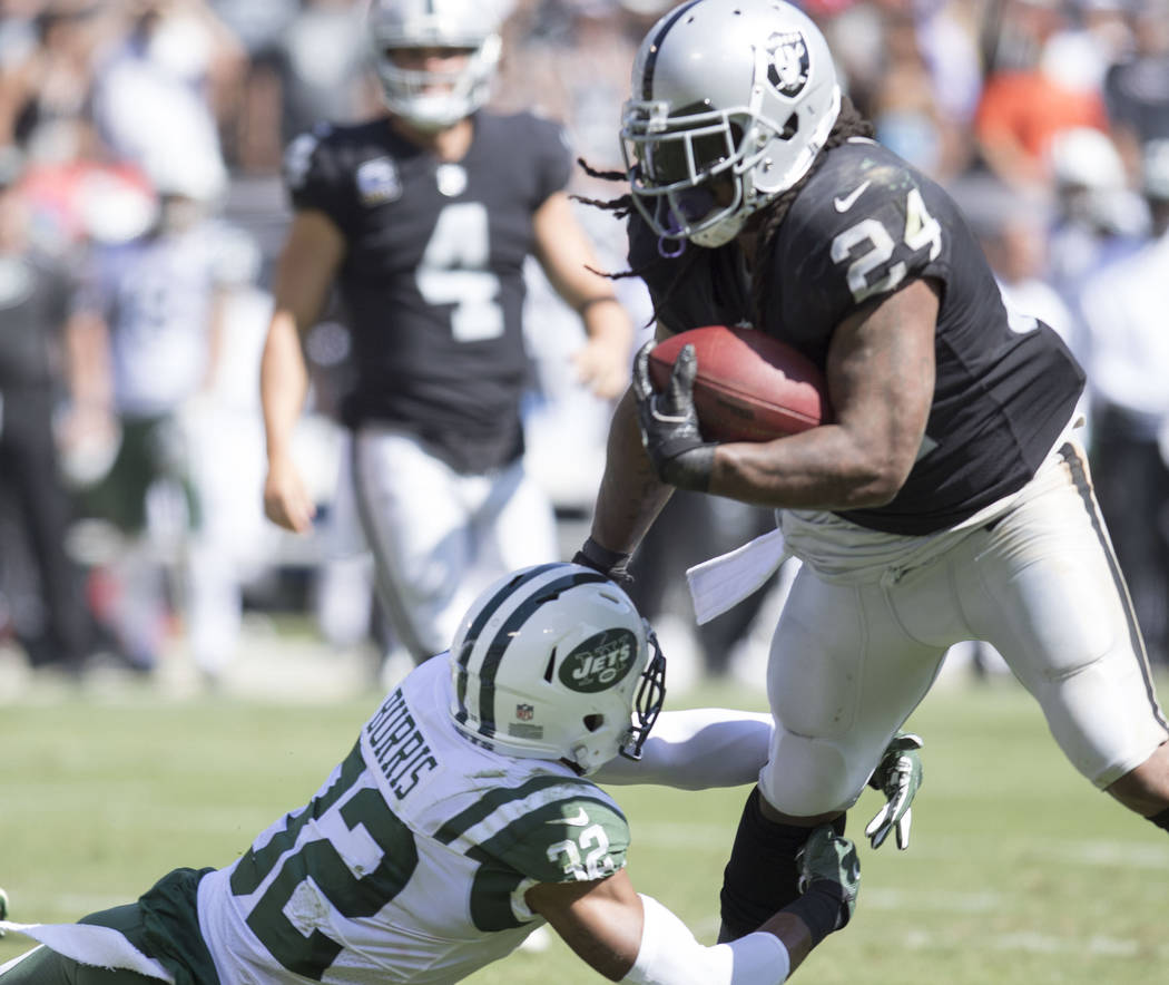 Oakland Raiders running back Marshawn Lynch (24) avoids a tackle from New York Jets cornerback Juston Burris (32) in the first half of their game in Oakland, Calif., Sunday, Sept. 17, 2017. Heidi  ...