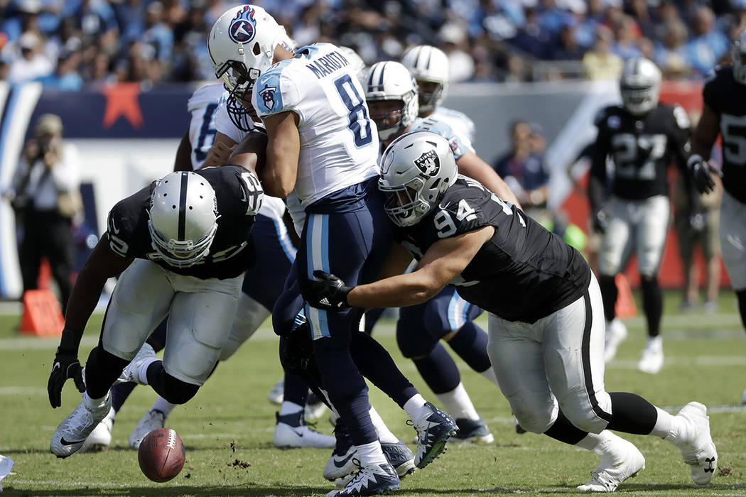 Oakland Raiders defensive end Khalil Mack (52) and defensive tackle Eddie Vanderdoes (94) chase after a fumble by Tennessee Titans quarterback Marcus Mariota (8) in the second half of an NFL footb ...