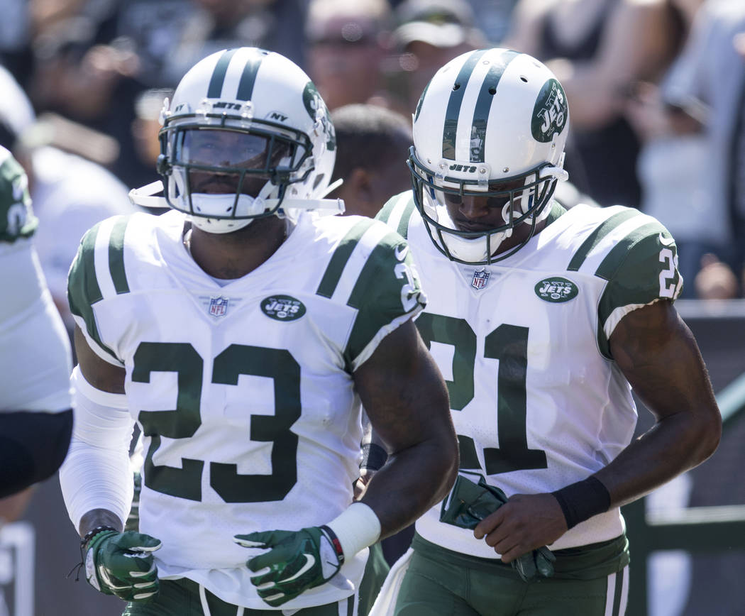 New York Jets defensive back Terrence Brooks (23) and cornerback Morris Claiborne (21) make their way onto the field in the first half of their game in Oakland, Calif., Sunday, Sept. 17, 2017. Hei ...