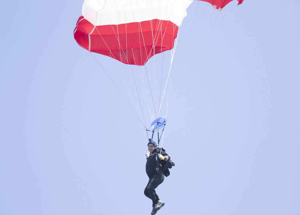 A parachuter prepares to land on the field of the Oakland-Alameda County Coliseum prior to the Oakland Raiders game against the New York Jets in Oakland, Calif., Sunday, Sept. 17, 2017. Heidi Fang ...