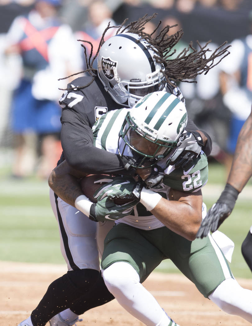 Oakland Raiders free safety Reggie Nelson (27) tackles New York Jets running back Matt Forte (22) in the first half of their game in Oakland, Calif., Sunday, Sept. 17, 2017. Heidi Fang Las Vegas R ...