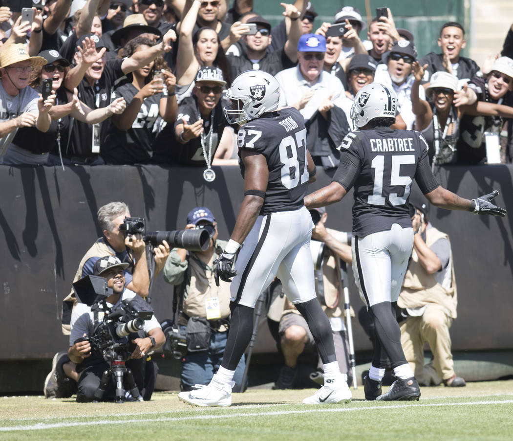 Oakland Raiders wide receiver Michael Crabtree (15) celebrates scoring a touchdown with tight end Jared Cook (87) in the first half of their game against the New York Jets in Oakland, Calif., Sund ...