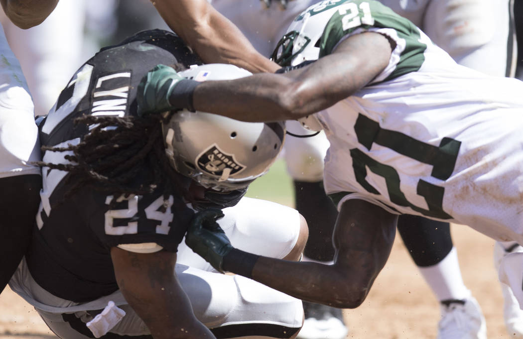 Oakland Raiders running back Marshawn Lynch (24) is tackled by New York Jets cornerback Morris Claiborne (21) in the first half of their game in Oakland, Calif., Sunday, Sept. 17, 2017. Heidi Fang ...