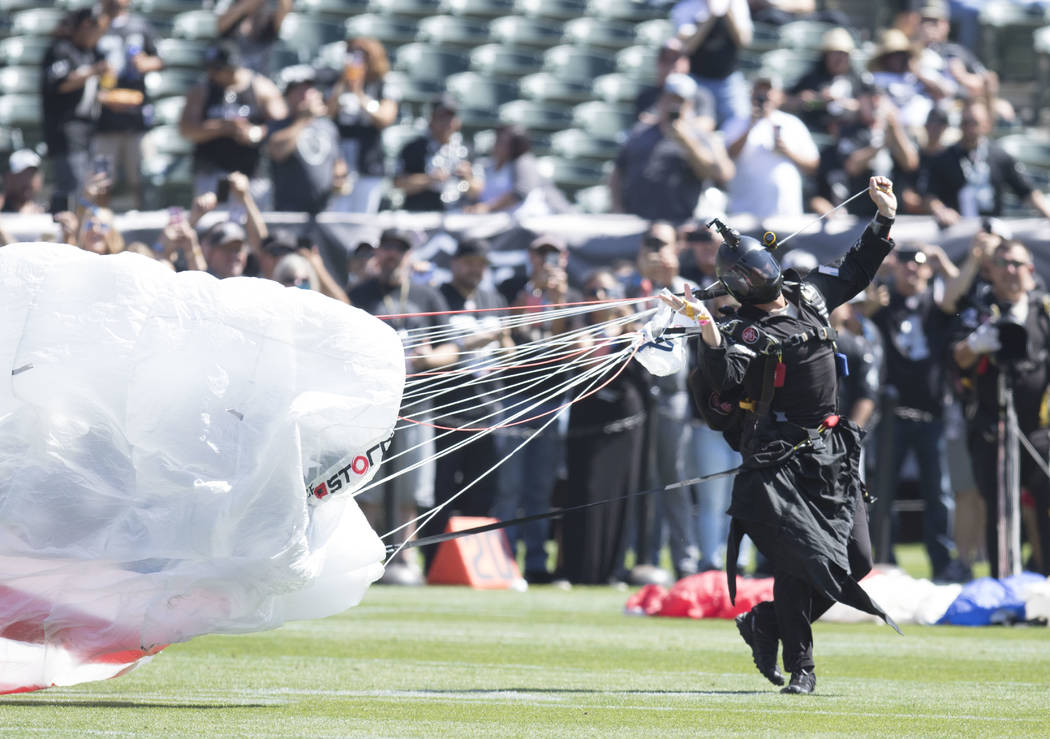 A parachuter lands on the Oakland-Alameda County Coliseum field prior to the start of the Raiders game against the New York Jets in Oakland, Calif., Sunday, Sept. 17, 2017. Heidi Fang Las Vegas Re ...