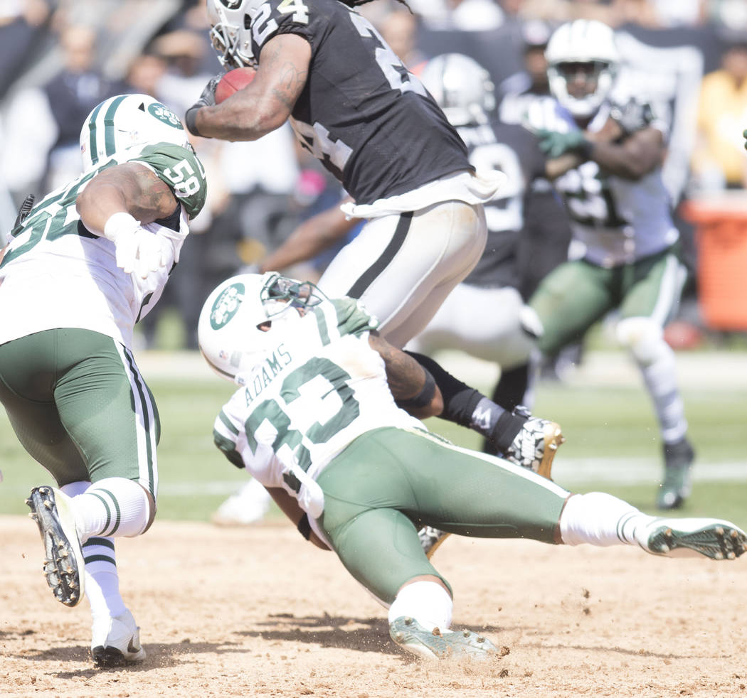 Oakland Raiders running back Marshawn Lynch (24) breaks a tackle by New York Jets strong safety Jamal Adams (33) in the first half of their game in Oakland, Calif., Sunday, Sept. 17, 2017. Heidi F ...