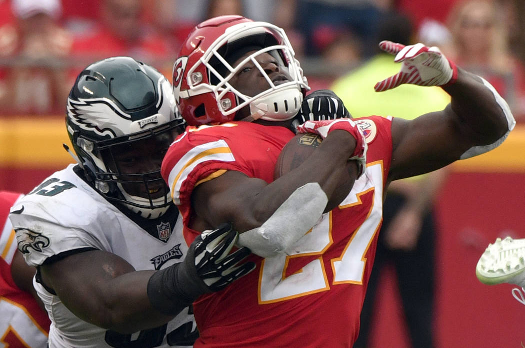Kansas City Chiefs running back Kareem Hunt (27) is tackled by Philadelphia Eagles defensive tackle Tim Jernigan (93) during the second half of an NFL football game in Kansas City, Mo., Sunday, Se ...