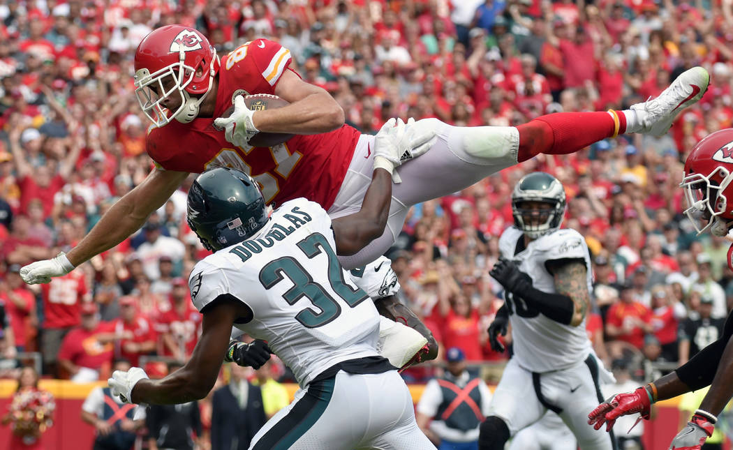 Kansas City Chiefs tight end Travis Kelce (87) leaps over Philadelphia Eagles cornerback Rasul Douglas (32) for a touchdown during the second half of an NFL football game in Kansas City, Mo., Sund ...
