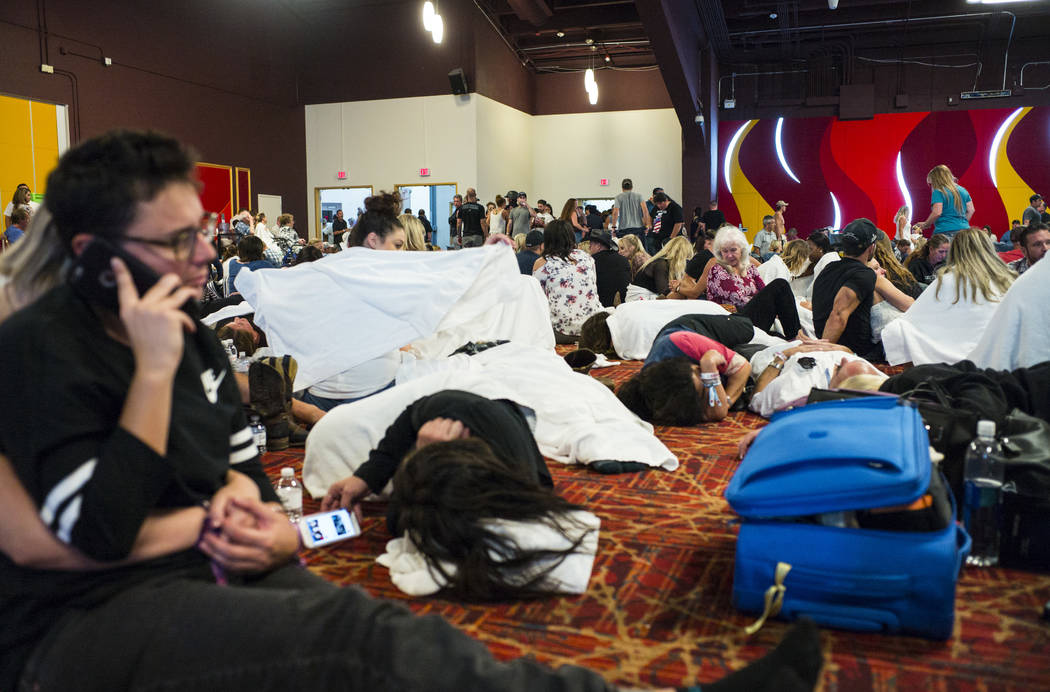 People relax in a convention center area during lockdown at the Tropicana Las Vegas following an active shooter situation that left 50 dead and over 200 injured on the Las Vegas Strip during the e ...