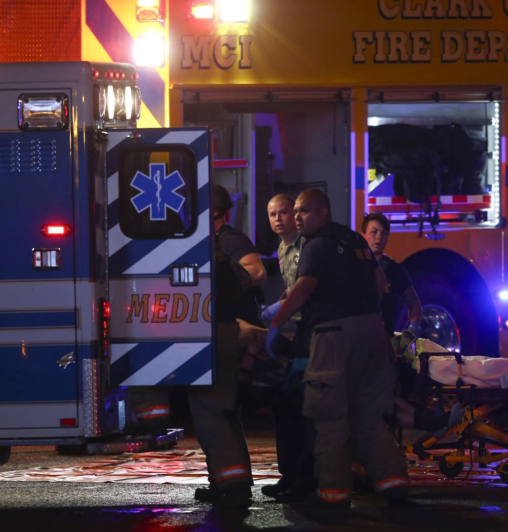 A body is loaded into an ambulance by emergency workers as Las Vegas police respond during an active shooter situation on the Las Vegas Strip on Sunday, Oct. 1, 2017. Chase Stevens Las Vegas Revie ...