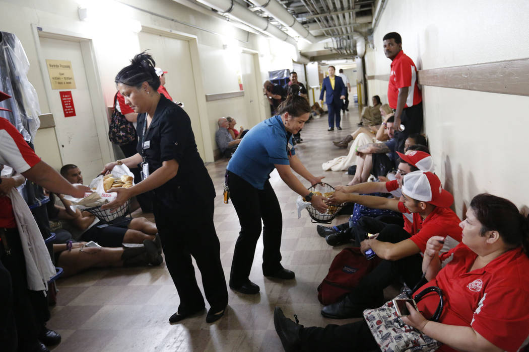 Luxor staff members bring bread to the evacuees during a shooting, Monday Oct. 2, 2017, in Las Vegas. People have been evacuated in the basement at the Luxor.  Chitose Suzuki Las Vegas Review-Journal