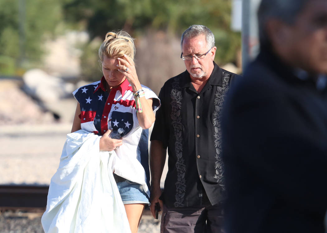 Kathy Boggio-Mocnik, left, and her husband Gary, both of Aliso Viejo, Calif., return to Mandalay Bay hotel-casino on Monday, Oct. 2, 2017 where at least 58 people were killed and more than 400 oth ...