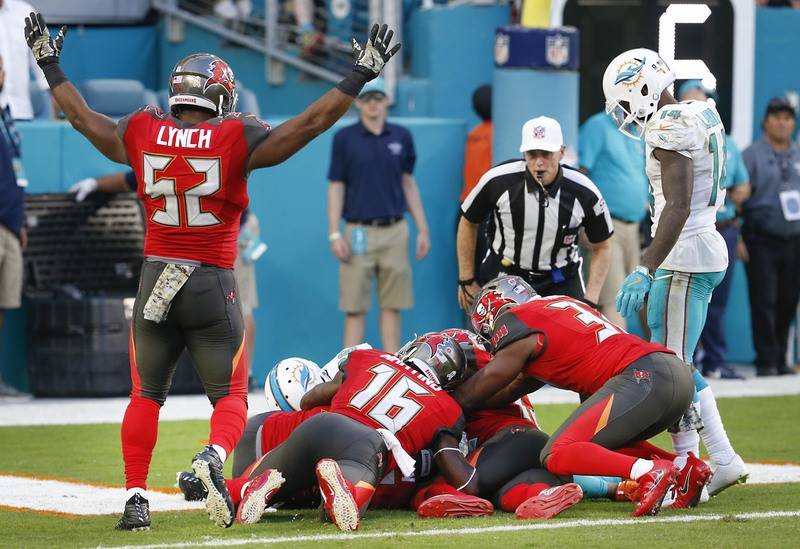 The Tampa Bay Buccaneers fall on a fumbled ball in the end zone for a touchdown during the second half against the Miami Dolphins at Hard Rock Stadium in Miami Gardens, Florida, Nov. 19, 2017. ( R ...
