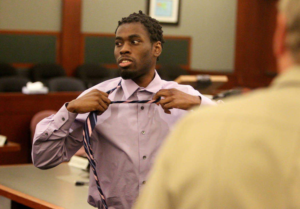 Bryan Clay removes his tie after being found guilty at the Regional Justice Center on Tuesday, ...