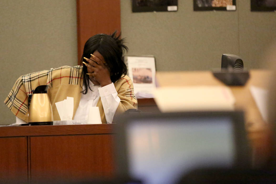 Latasha White, the mother of Bryan Clay, the Las Vegas man convicted of raping and murdering a mother and her 10-year-old daughter, breaks down as she looks through pictures presented by the defen ...