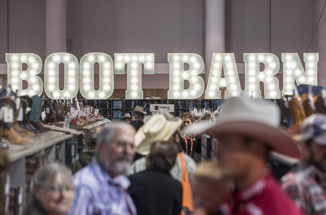 Shoppers peruse the aisles at Boot Barn during Cowboy Christmas on Thursday, Dec. 7, 2017, at t ...