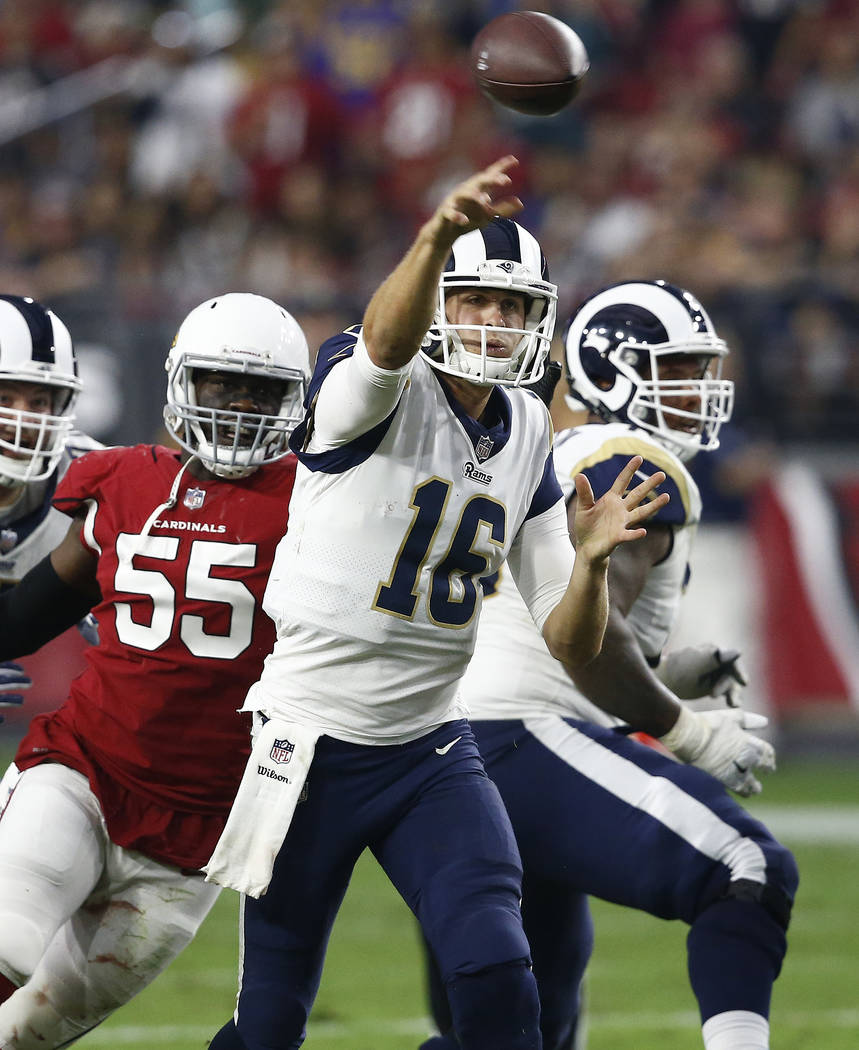 Los Angeles Rams quarterback Jared Goff (16) throws as Arizona Cardinals outside linebacker Chandler Jones (55) pursues during the second half of an NFL football game, Sunday, Dec. 3, 2017, in Gle ...