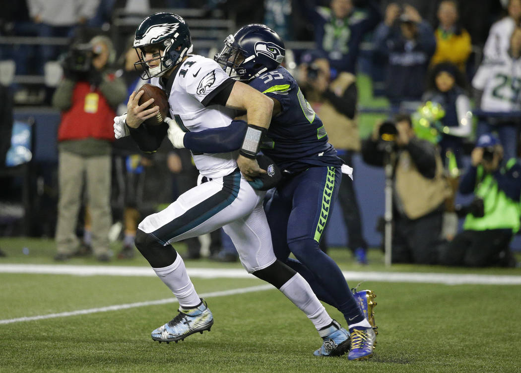 Seattle Seahawks defensive end Frank Clark, right, sacks Philadelphia Eagles quarterback Carson Wentz (11) in the second half of an NFL football game Sunday, Dec. 3, 2017, in Seattle. The Seahawks ...