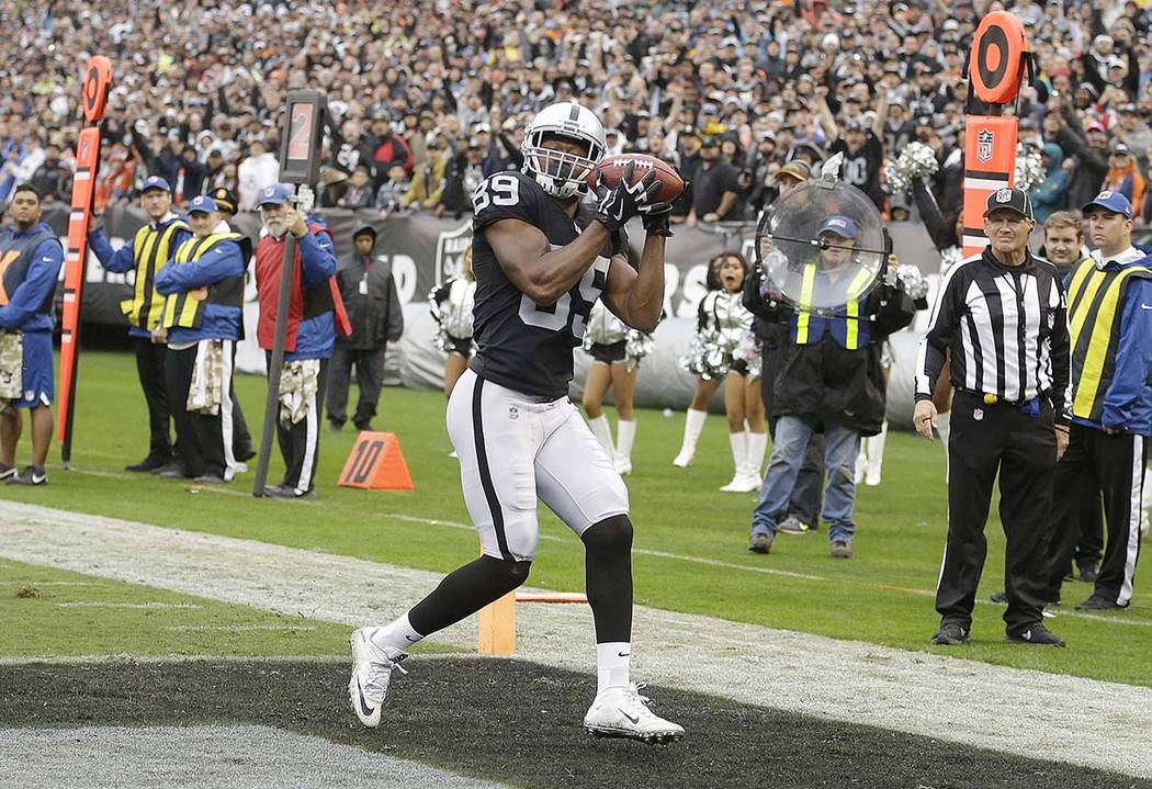 Oakland Raiders wide receiver Amari Cooper (89) catches a touchdown pass against the Denver Broncos during the first half of an NFL football game in Oakland, Calif., Sunday, Nov. 26, 2017. (AP Pho ...