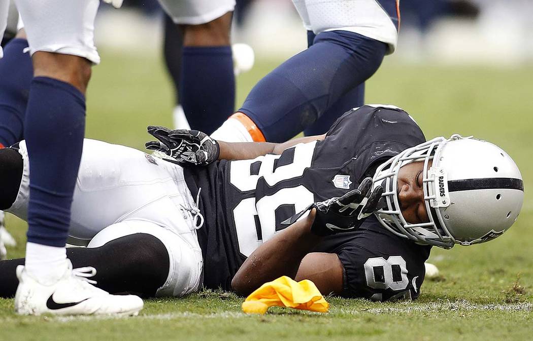 Oakland Raiders wide receiver Amari Cooper (89) remains on the ground after a hit by the Denver Broncos during the first half of an NFL football game in Oakland, Calif., Sunday, Nov. 26, 2017. (AP ...