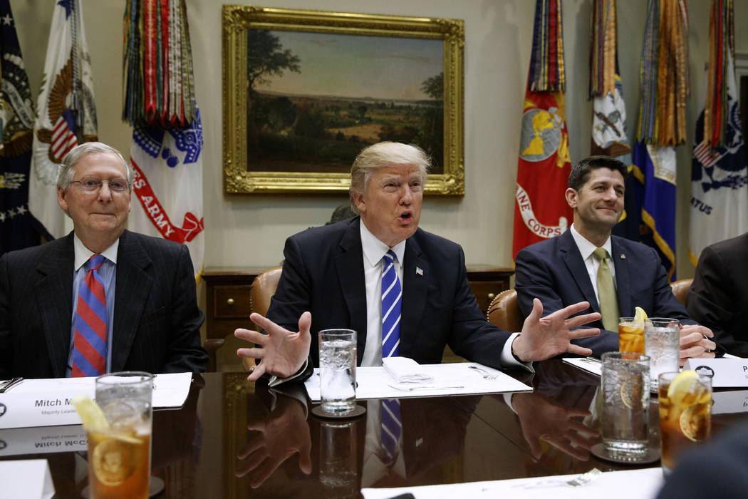 FILE - In this March 1, 2017 file photo, President Donald Trump, flanked by Senate Majority Leader Mitch McConnell of Ky., left, and House Speaker Paul Ryan of Wis., speaks during a meeting with H ...