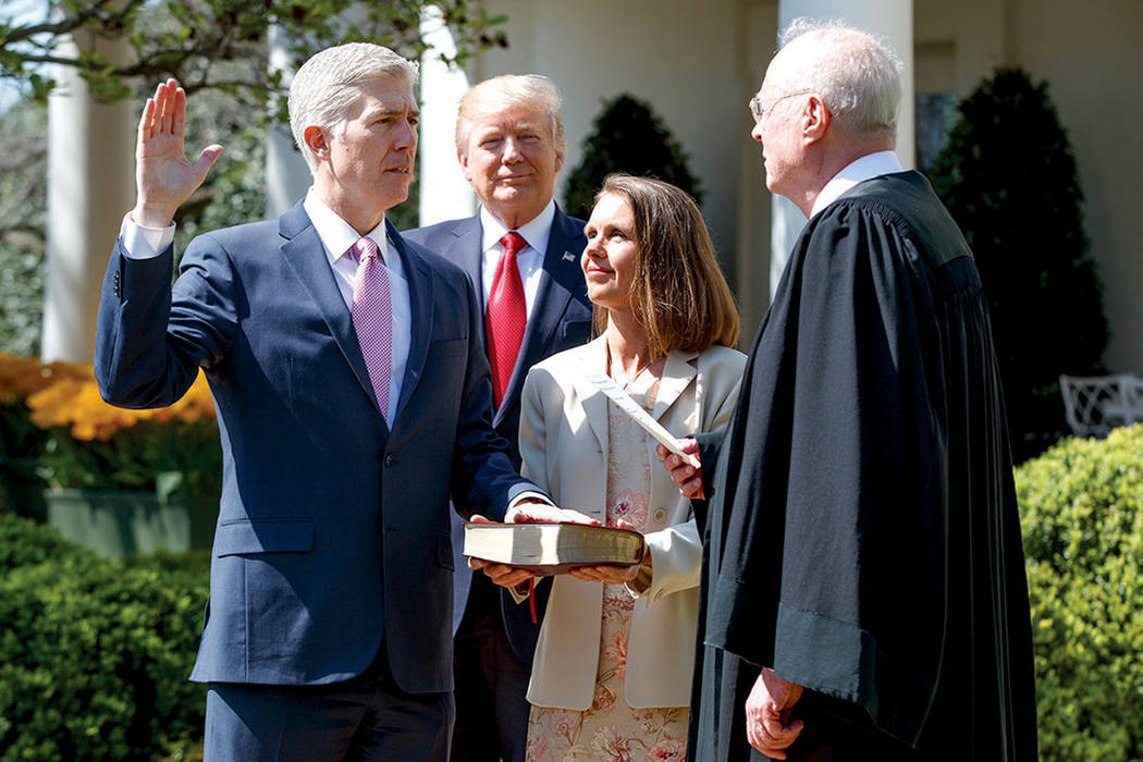 Judge Neil Gorsuch is sworn in as an associate justice of the Supreme Court by Supreme Court Associate Justice Anthony Kennedy as President Donald J. Trump watches with Louise Gorsuch in the Rose  ...