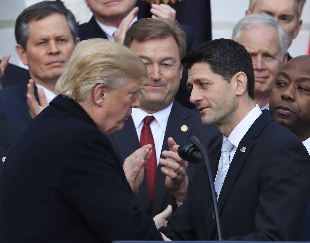 President Donald Trump shakes hands with House Speaker Paul Ryan of Wis., during an event to acknowledge the final passage of tax overhaul legislation by Congress on the South Lawn of White House  ...