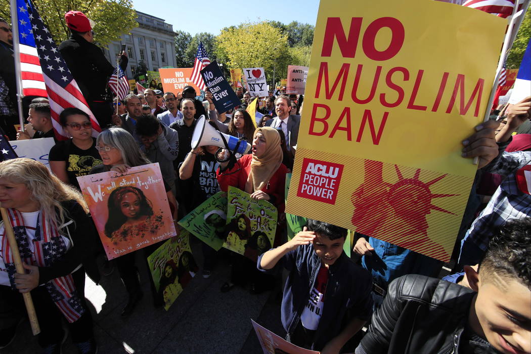 FILE - In this Oct. 18, 2017, file photo, protesters gather at a rally in Washington. The Supreme Court is allowing the Trump administration to fully enforce a ban on travel to the United States b ...