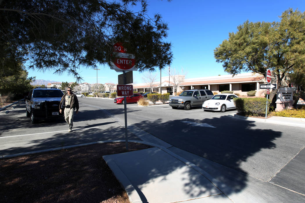 A ranger checks on a photographer at a closed U.S. Government office building at 4701 N. Torrey Pines Drive in Las Vegas Monday, Jan. 22, 2018. The building that houses the Bureau of Land Manageme ...