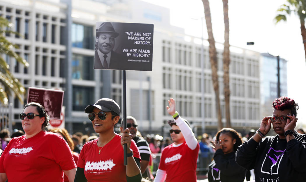 Members of Voices march during the 36th annual Dr. Martin Luther King Jr. Parade, themed "Living the Dream: Building a Bridge to Unity," in downtown Las Vegas, Jan. 15, 2018. The parade featured f ...