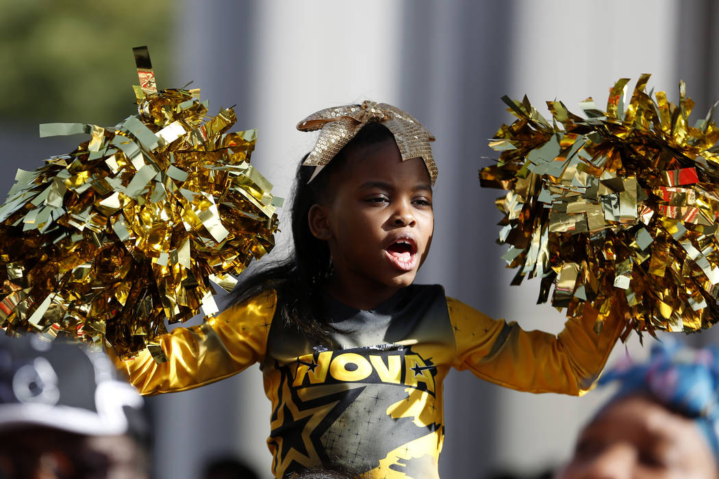 Ny'Lei Patterson, 7, cheers for participants marching in the 36th annual Dr. Martin Luther King Jr. Parade, themed "Living the Dream: Building a Bridge to Unity" in downtown Las Vegas, Jan. 15, 20 ...