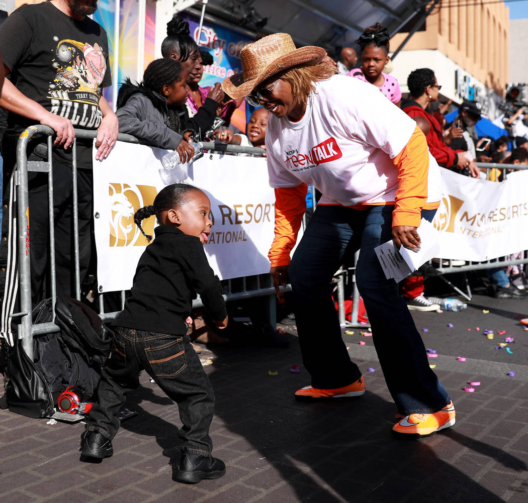 Marquiste Kiles, 2, and Annette Walker Goggins dance during the 36th annual Dr. Martin Luther King Jr. Parade, themed "Living the Dream: Building a Bridge to Unity" in downtown Las Vegas, Jan. 15, ...