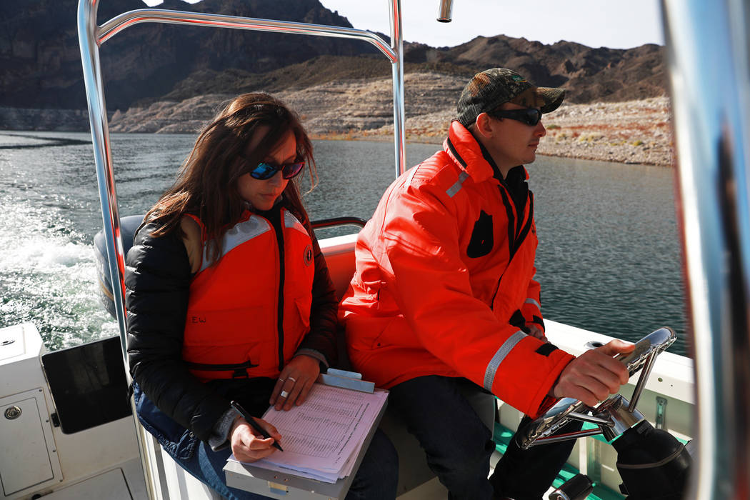 From left, Nichelle Rich, 33, and Ben Smith, 30, partake in a bald eagle survey at Lake Mead Na ...