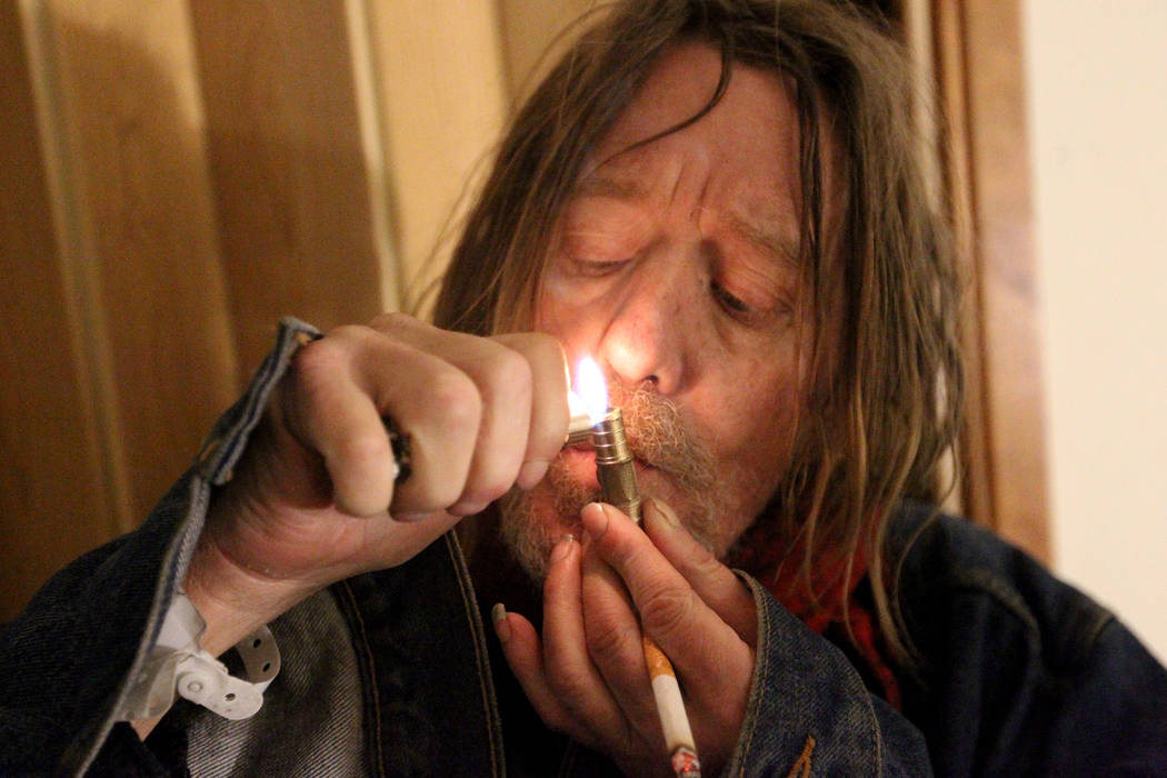 Gary, who declined to give his last name, smokes what he said is marijuana in his room at 724 N. 9th St. in downtown Las Vegas Thursday, Jan. 25, 2018. The home was part of a Nevada state program ...