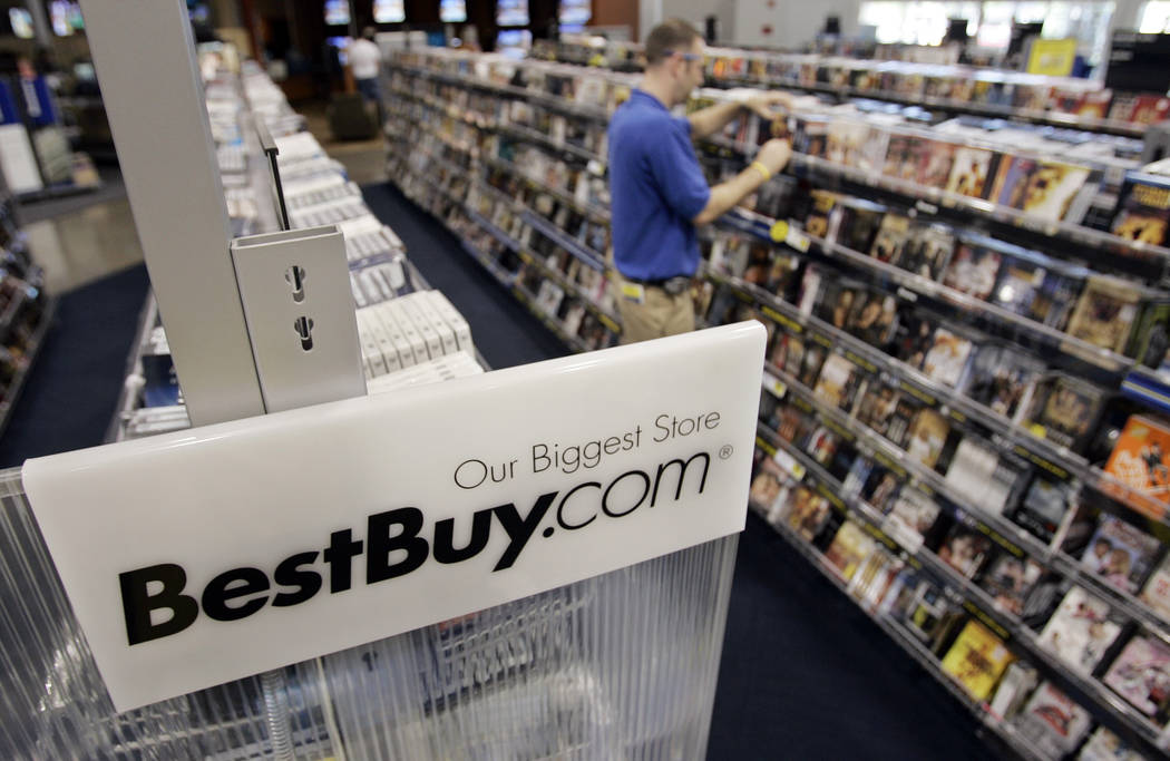 A Best Buy sign is posted next to a display of movie DVDs and music CDs at a Best Buy store in Mountain View, Calif., Tuesday, June 19, 2007. Best Buy Co., the nation's largest consumer electronic ...