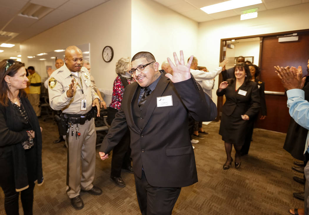 Former gang member Andrew Arevalo is greeted with high fives and applause before the Hope for Prisoners graduation ceremony at the Las Vegas Metropolitan Police Headquarters in Las Vegas on Friday ...