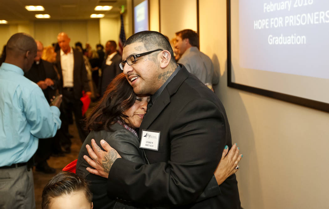 Former gang member Andrew Arevalo hugs his mother Anyela Arevalo following the Hope for Prisoners graduation ceremony at the Las Vegas Metropolitan Police Headquarters in Las Vegas on Friday, Feb. ...