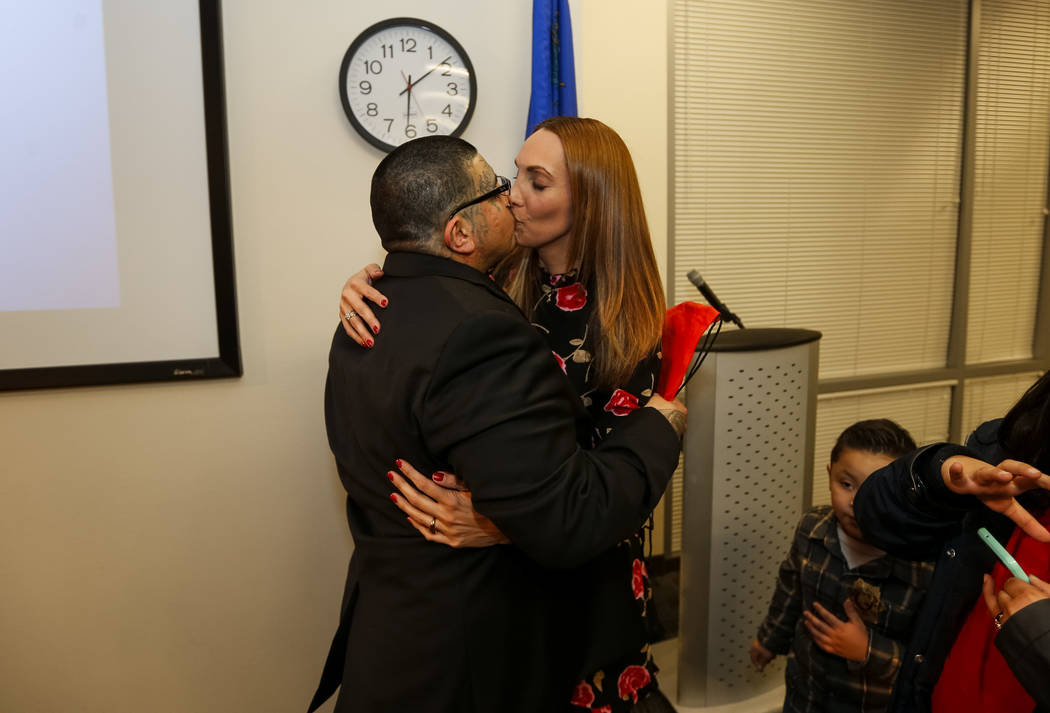 Attorney Alexis Plunkett and her boyfriend Andrew Arevalo share a kiss following the Hope for Prisoners graduation ceremony at the Las Vegas Metropolitan Police Headquarters in Las Vegas on Friday ...