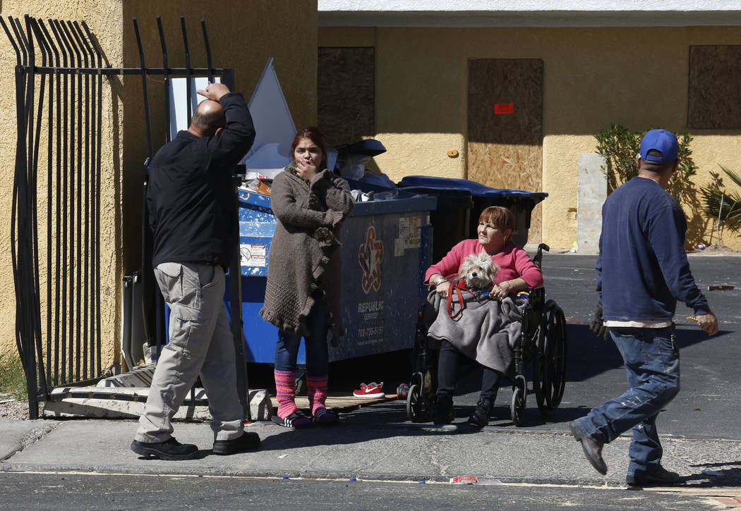 Tenants, including Paloma Castrejon, center, and her dog Princess gather outside their boarded up apartment on Monday, March 5, 2018 at Las Haciendas Apartments at 2504 Las Vegas Blvd., North. Twe ...