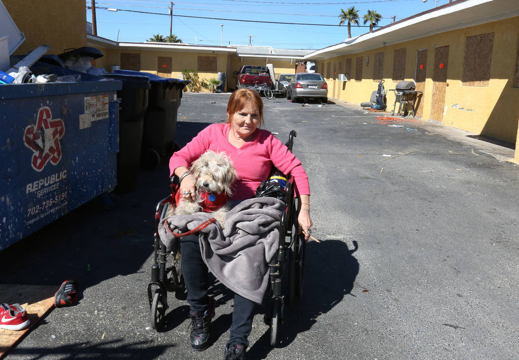 Paloma Castrejon, resident at Las Haciendas Apartments at 2504 Las Vegas Blvd North, sits with her dog Princess outside her boarded up apartment on Monday, March 5, 2018, in Las Vegas. Twenty five ...