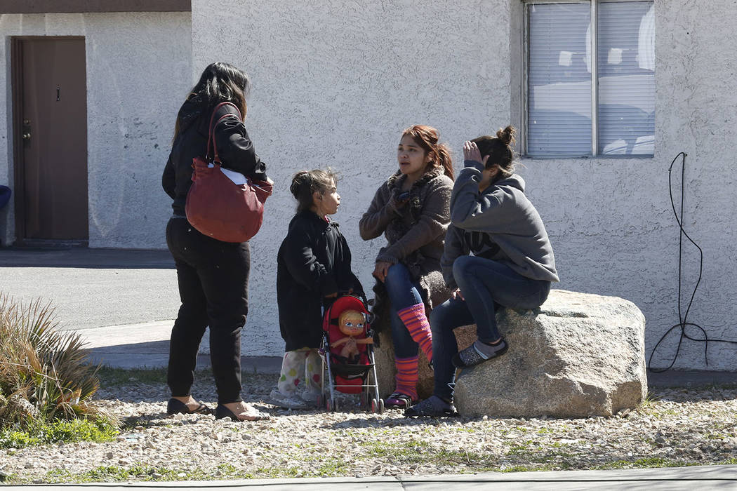 Tenants gather outside their boarded up apartment on Monday, March 5, 2018 at Las Haciendas Apartments at 2504 Las Vegas Blvd., North. Twenty five families were evicted from their apartment. Bizua ...
