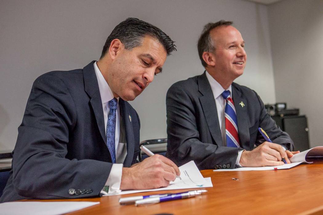 From left, Nevada Gov. Brian Sandoval and Delaware Governor Markell sign a multi-state Internet gaming agreement on Tuesday, Feb. 25, 2014 in Wilmington, Del.  (AP Photo/The Wilmington News-Journa ...