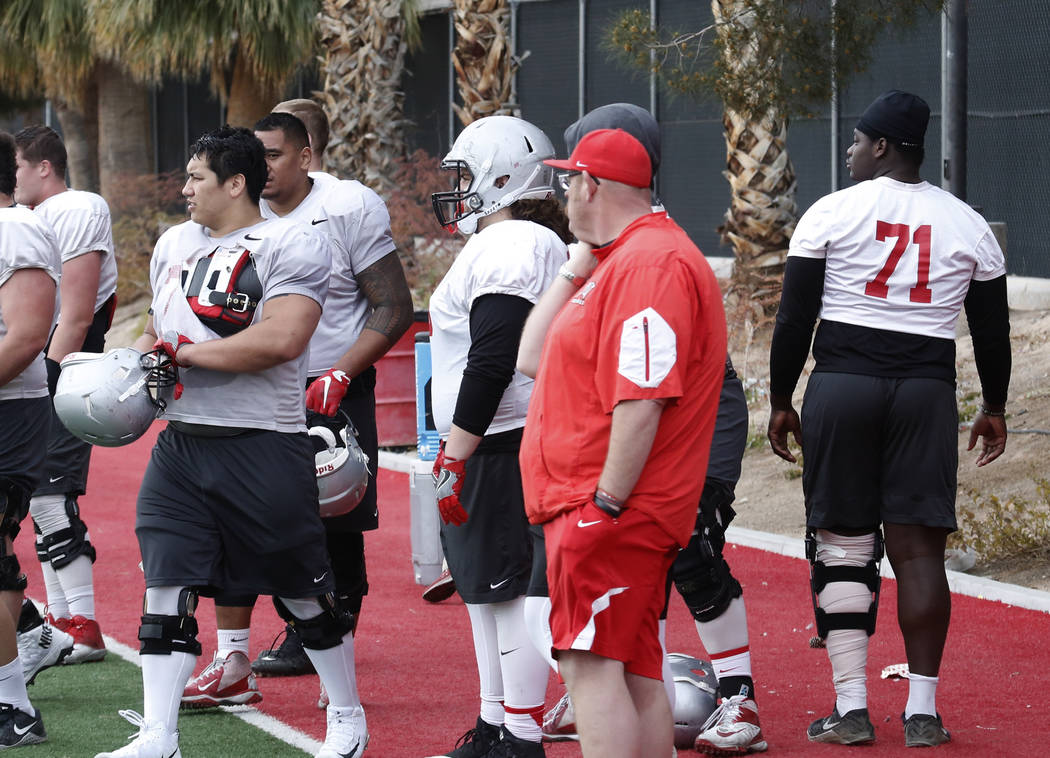 UNLV center Sid Acosta, left, prepares to enter the field as Justice Oluwaseun (71) walks on the sideline during team practice on Tuesday, March 20, 2018, in Las Vegas. Bizuayehu Tesfaye/Las Vegas ...