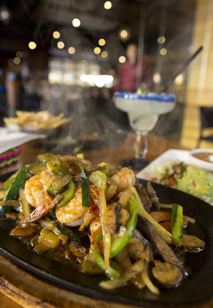 The carne asada and shrimp parillada (fajitas) entree served with the chips and salsa trio and a traditional margarita at Leticia's Mexican Cocina located at Tivoli Village at Queensridge in Las V ...