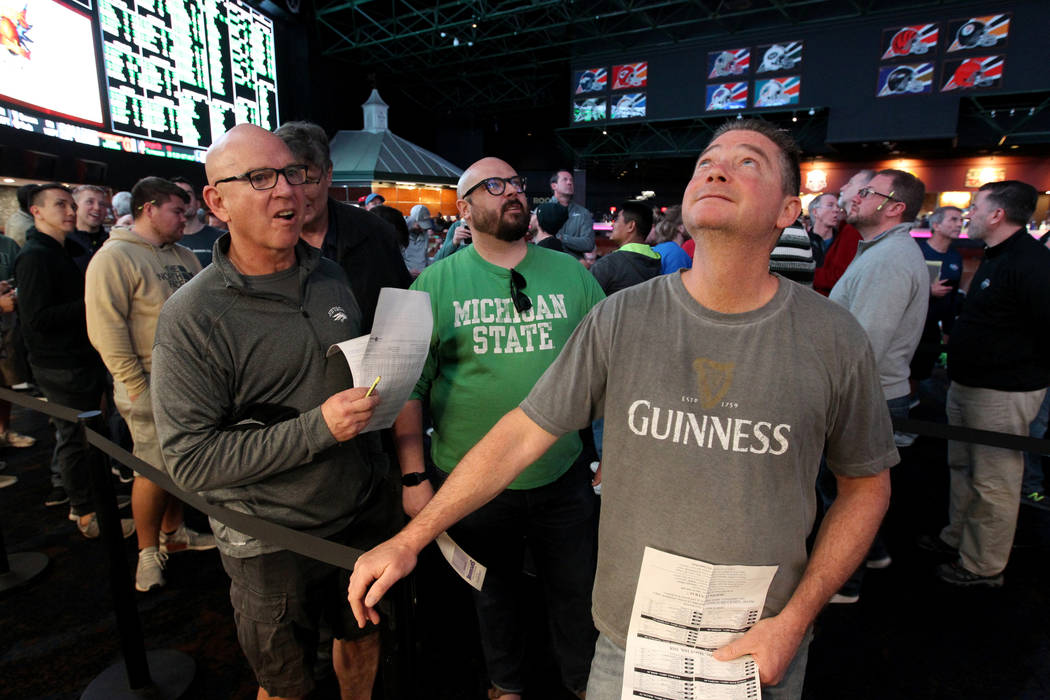 Steve Buckley of Boston, right, lines up to bet on basketball games during the NCAA Tournament at the Westgate Superbook in Las Vegas Thursday, March 15, 2018. K.M. Cannon Las Vegas Review-Journal ...