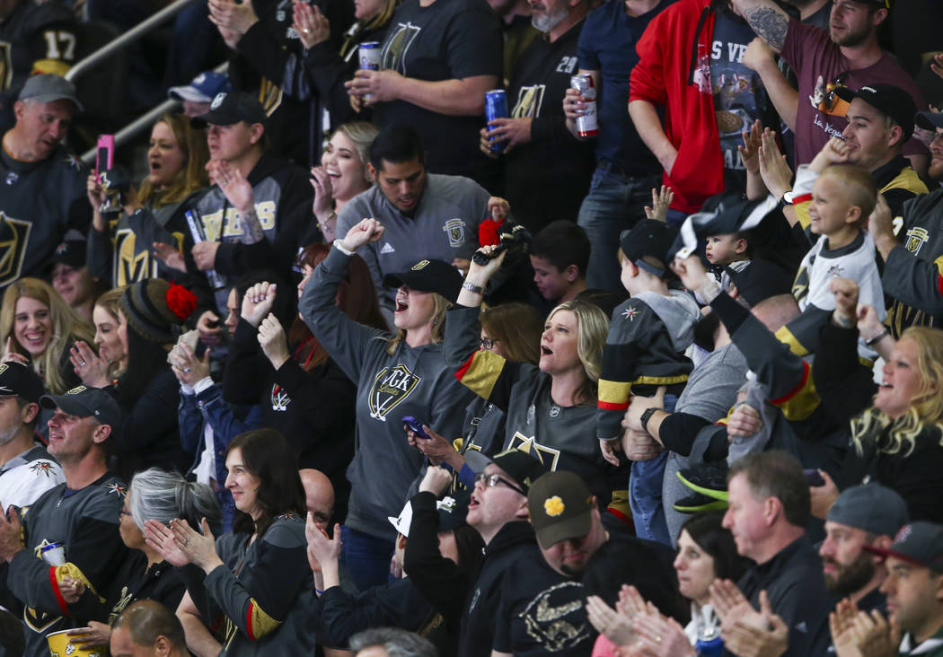 Golden Knights fans celebrate a goal by Golden Knights center Jonathan Marchessault, not pictured, during the second period of an NHL hockey game against the Colorado Avalanche at T-Mobile Arena i ...