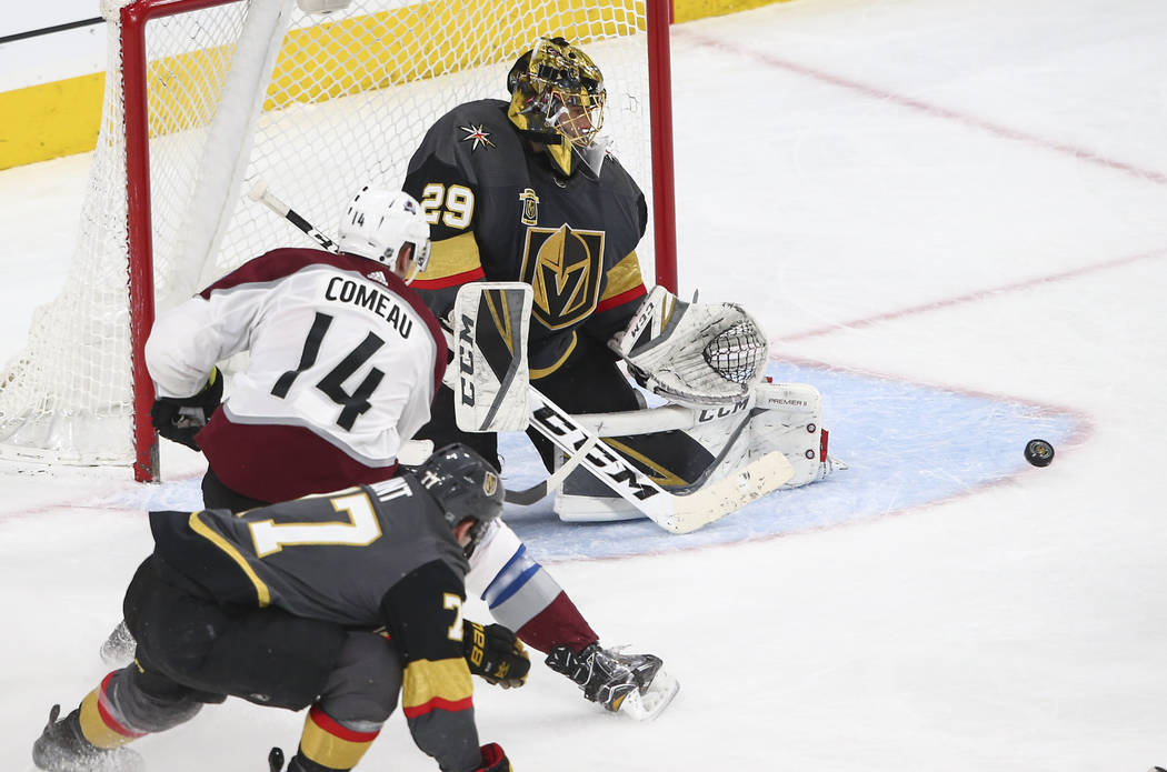 Golden Knights goaltender Marc-Andre Fleury (29) defends the goal as Colorado Avalanche left wing Blake Comeau (14) looks on during the second period of an NHL hockey game at T-Mobile Arena in Las ...