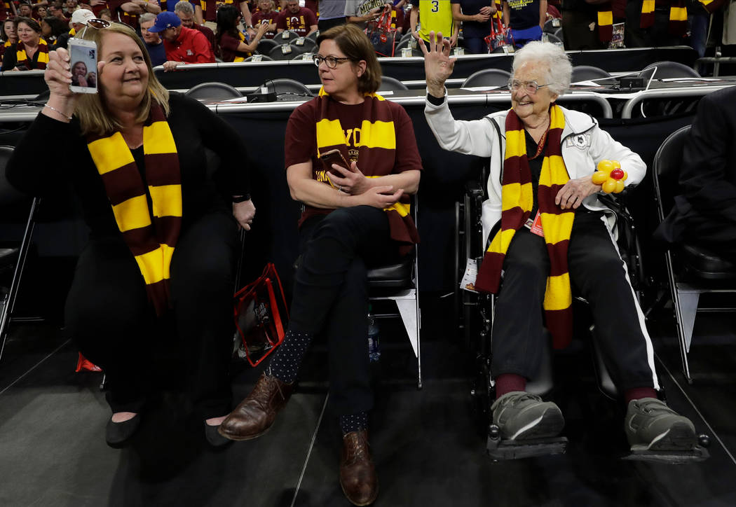 Loyola-Chicago's Sister Jean Dolores Schmidt, right, watches as players warm up before the semifinal game against Michigan in the Final Four NCAA college basketball tournament, Saturday, March 31, ...